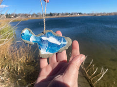Handmade resin ornament capturing ocean waves and sand texture