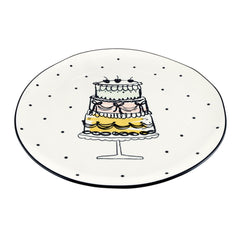 Round ceramic plate serving platter with irregular rim and black trim plus cake motif