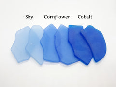 Flat machine-tumbled sea glass place cards with frosted surfaces and rounded edges