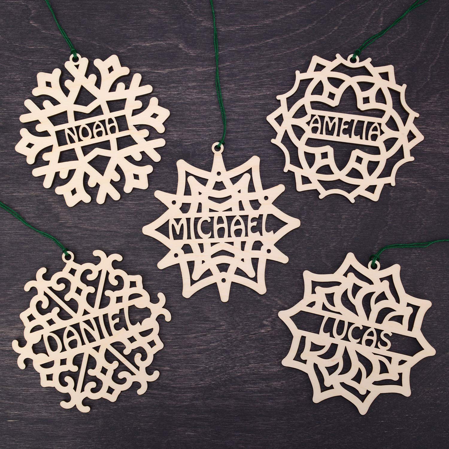 Five wooden snowflake ornaments from the Set of 5 Christmas Ornament Personalized set