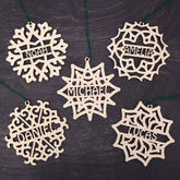 Five wooden snowflake ornaments from the Set of 5 Christmas Ornament Personalized set