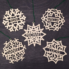 Five wooden snowflake ornaments from the Set of 5 Christmas Ornament Personalized set