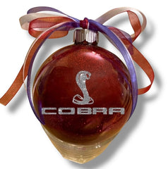 4 inch glass ornament with red glitter inside and silver accents
