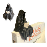 Sitting Ghost Figurine Reading a Book on a desk