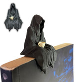 Sitting Ghost Figurine holding tea cup on bookshelf display