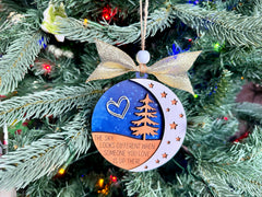 Ornament featuring a white heart motif and star cutouts on wood