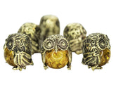 Small brass owl ornament front view with epoxy bead insert