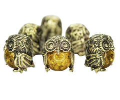 Small brass owl ornament front view with epoxy bead insert