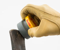 Stone cap protects the hand during use of the sharpener with groove grip