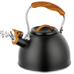 Black stainless steel tea kettle with wood pattern handle on stove top