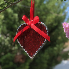 Coordinated ribbon hanging on red glass heart suncatcher