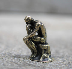 The Thinker by Rodin brass figurine close up