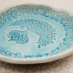 Turquoise glaze detail on round family tree tray