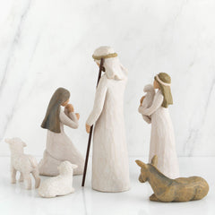 Mary kneeling figure with blue cape holding baby Jesus