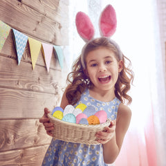 Decorative bowls jars baskets filled with pastel Easter eggs