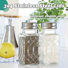 Two pack clear glass salt and pepper shakers on dining table