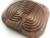 Wooden Contraptions walnut finger labyrinth on tabletop