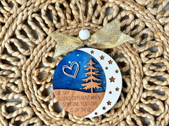 Natural wood grain variations on a memorial ornament