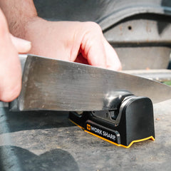 Compact design of Work Sharp Kitchen Edge Knife Sharpener beside cutting board
