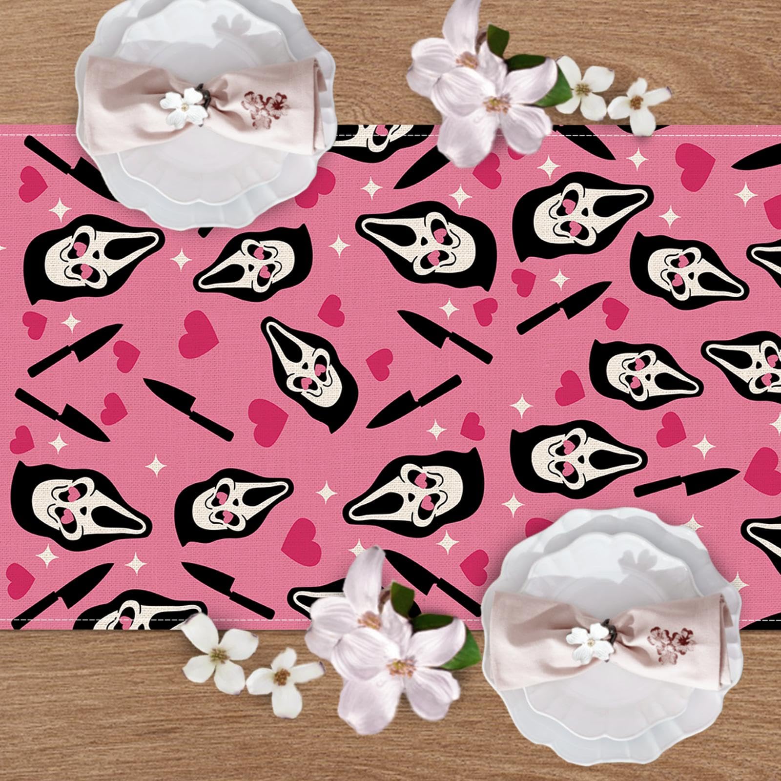 Halloween decor pink table runner shown with plates and candles