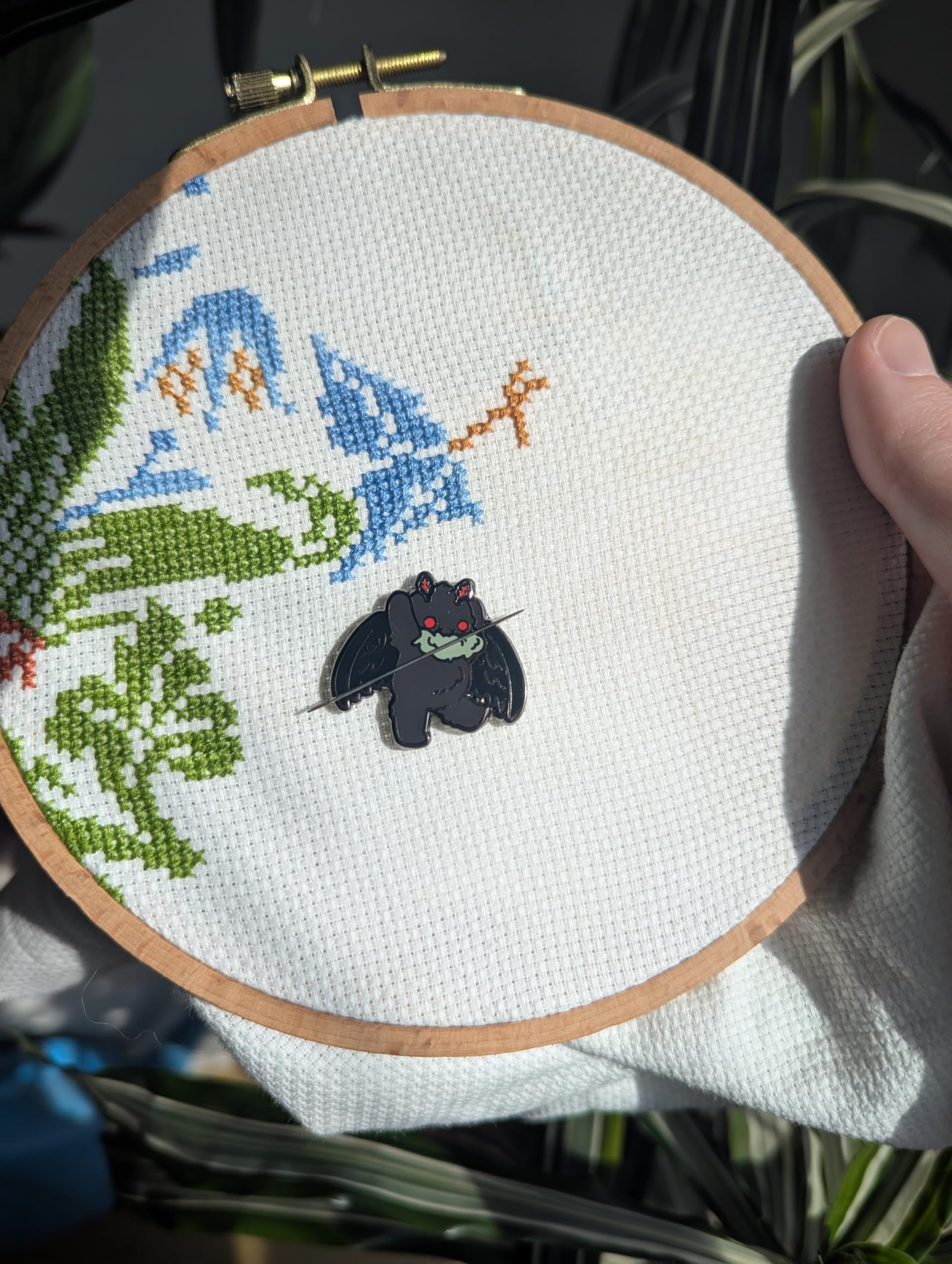 GingerStitchAu Mothman Needle Minder displayed on craft table