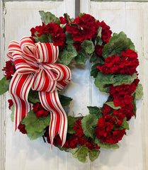 Handmade wreath featuring red geranium blooms