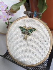 Magnetic needle minder for embroidery with two magnets