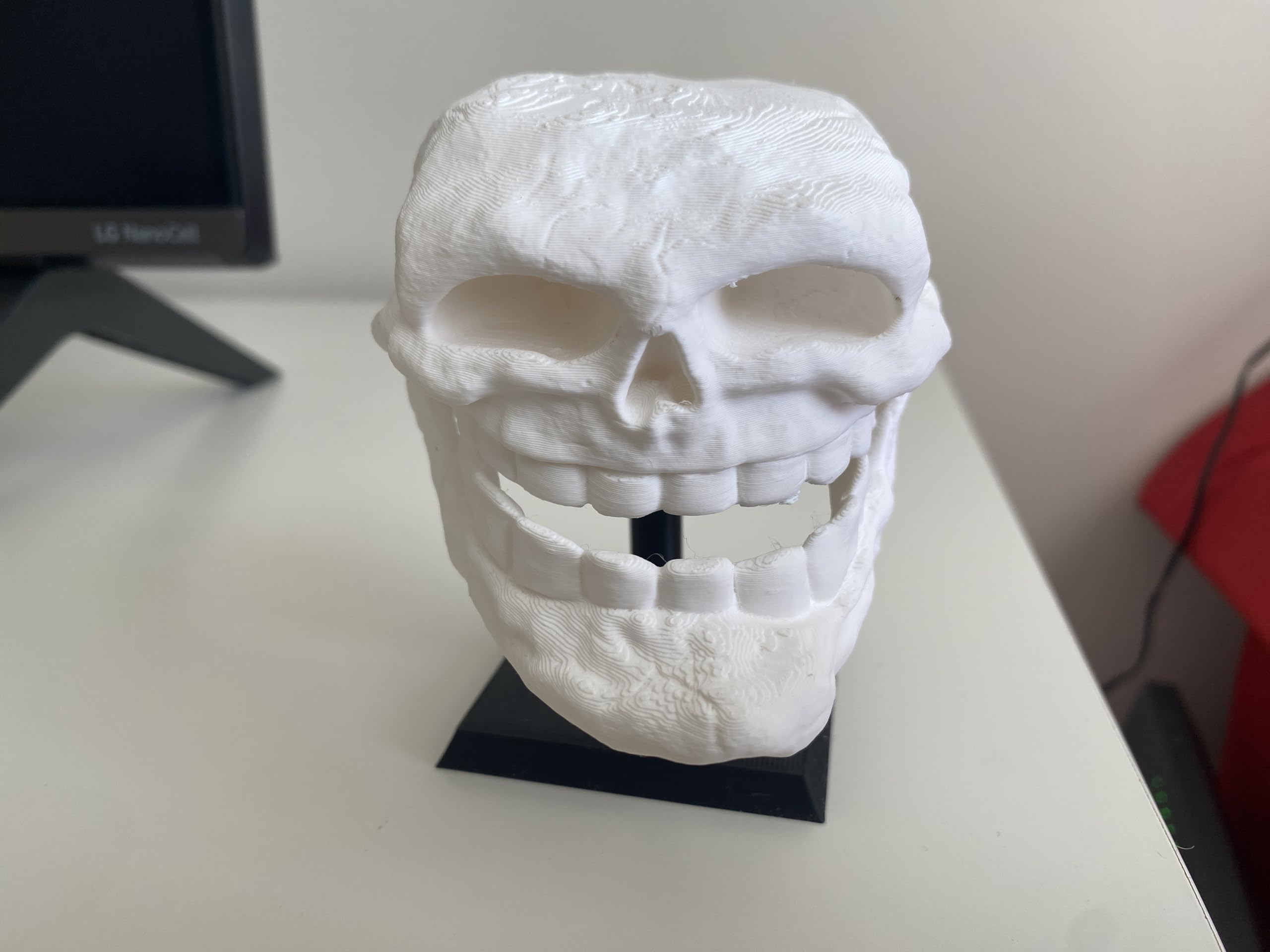 3D printed PLA Troll Face skull figurine displayed