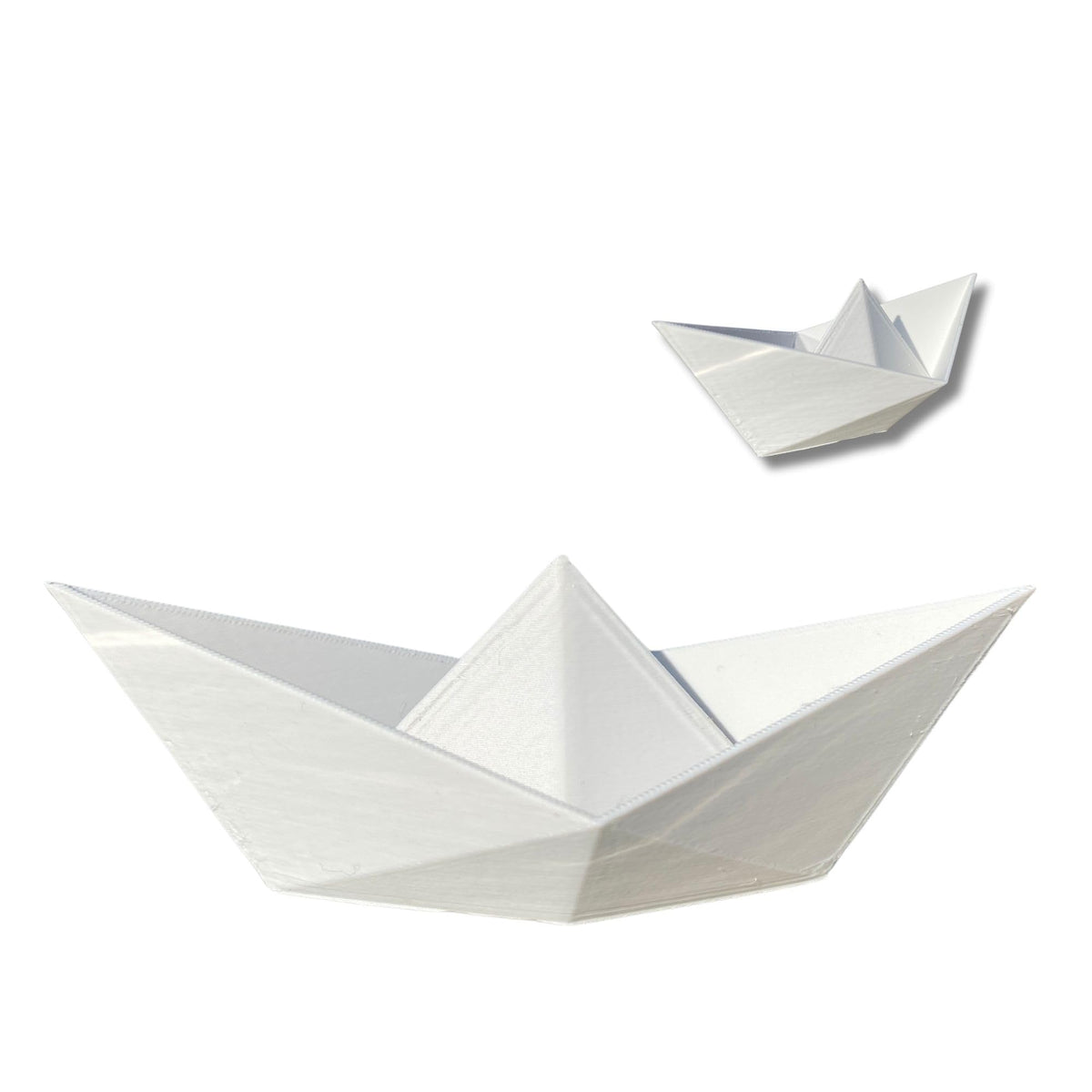 3D printed paper boat figurine on desk