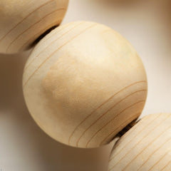 White washed wooden beads on garland with tassels