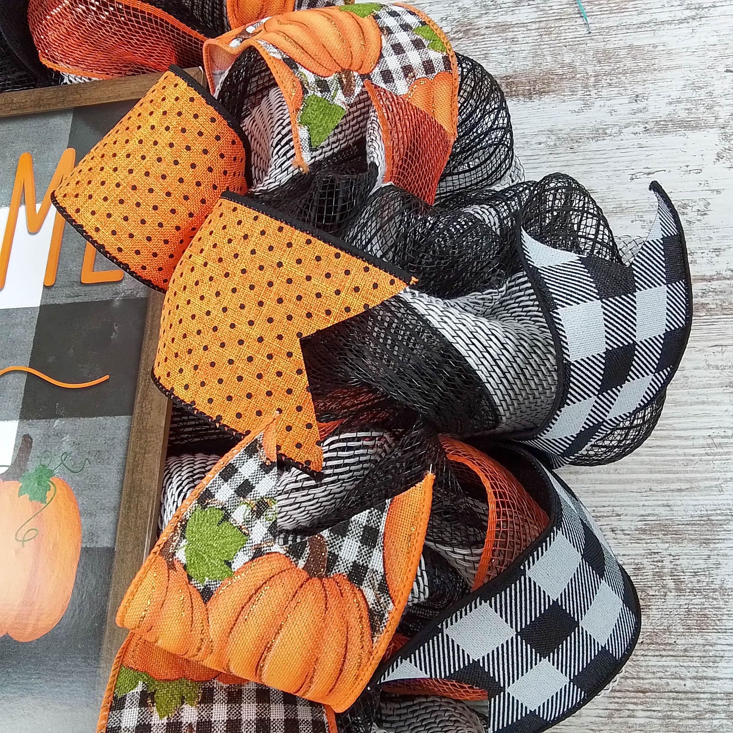 Black and orange farmhouse wreath with pumpkin accents