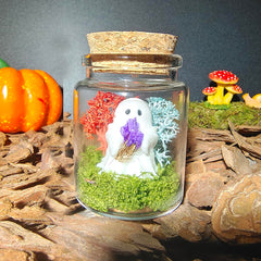 Purple forget-me-not flowers held by ghost