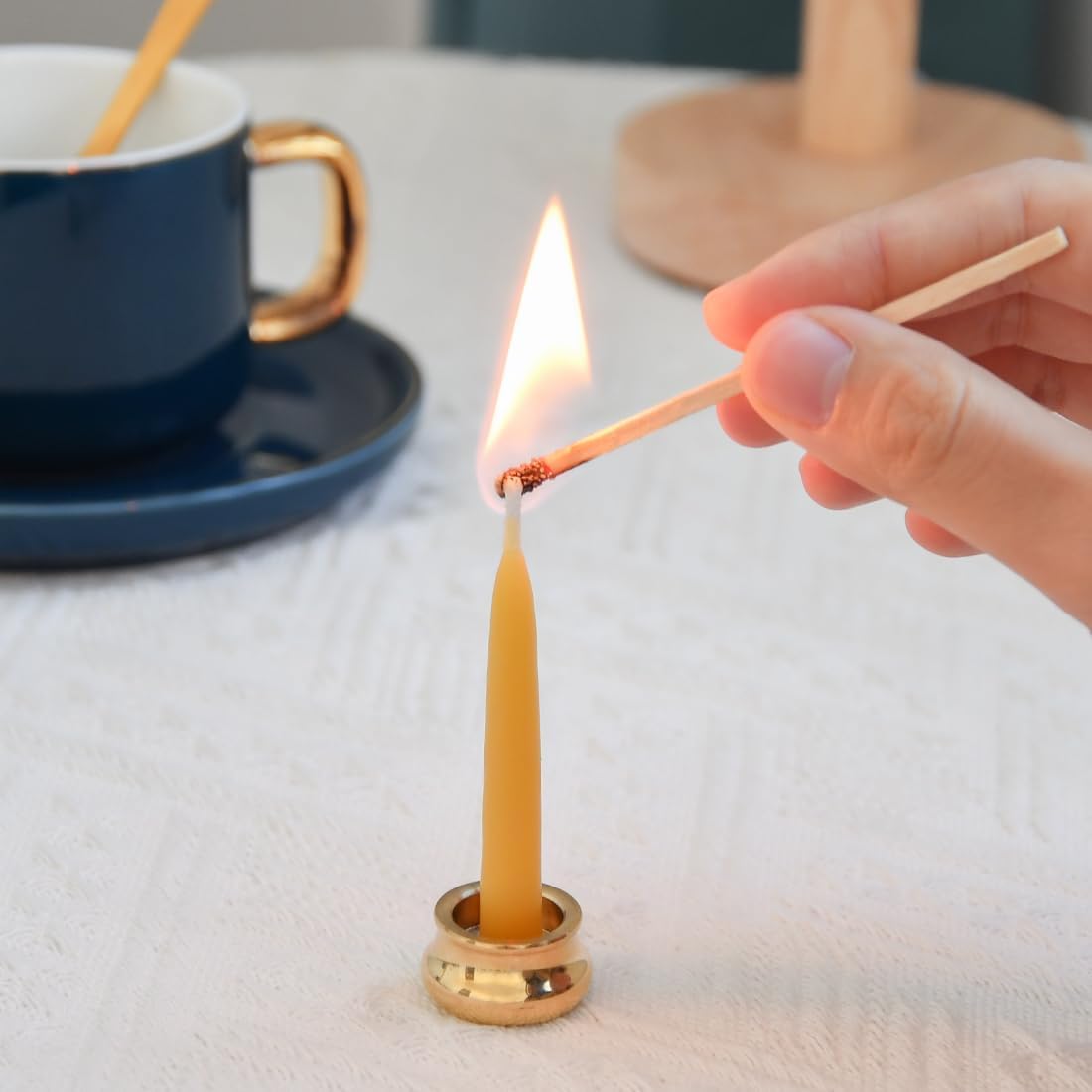 Brass candle holder with beeswax candle inserted