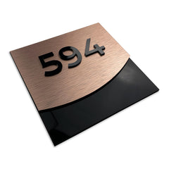 alumadesignco bronze hotel door numbers close up showing black acrylic base and top with silver aluminum core