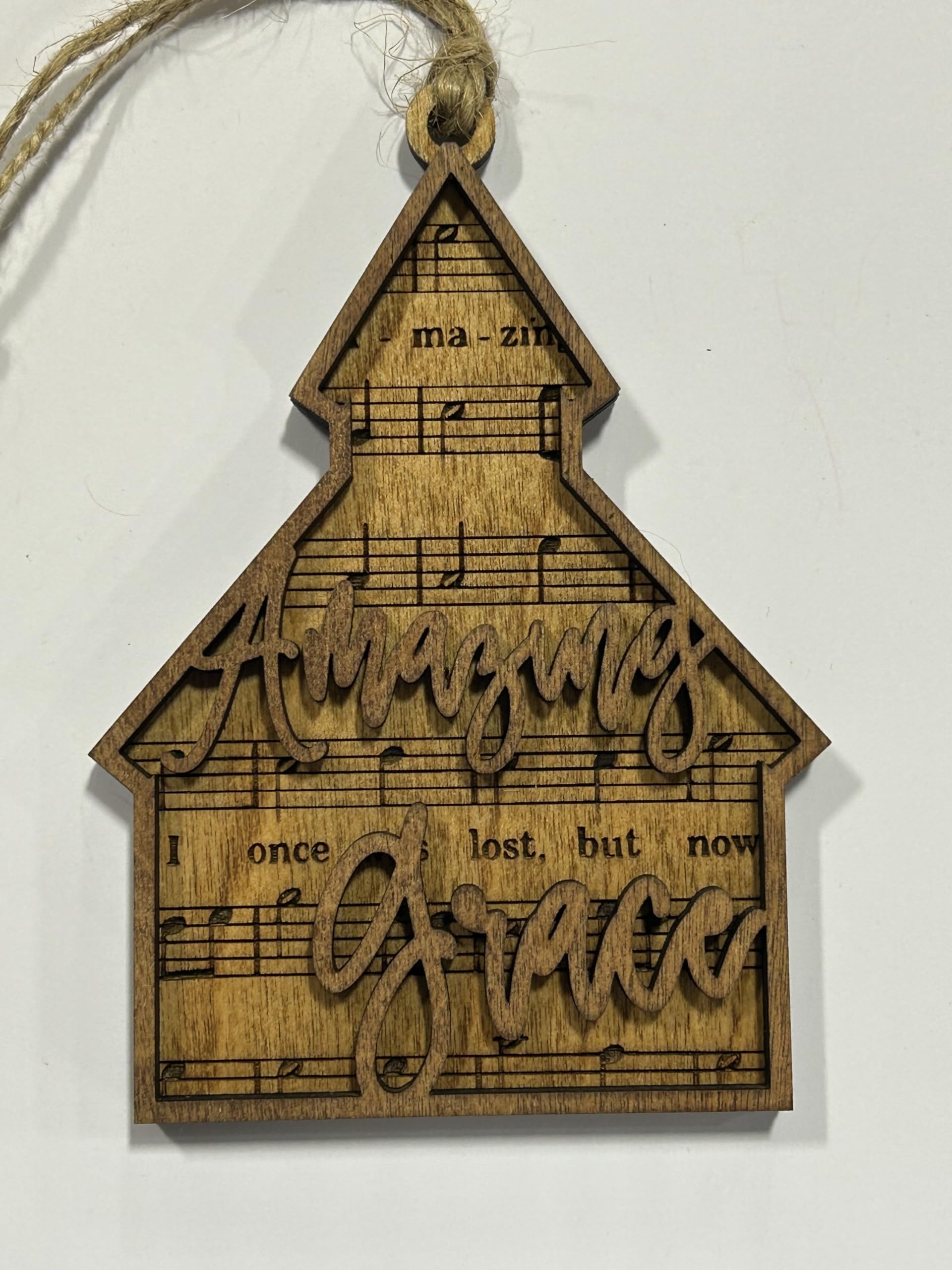 Back engraving shows music for Amazing Grace on ornament