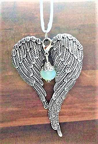 Antiqued metal angel wings ornament with satin cord for hanging