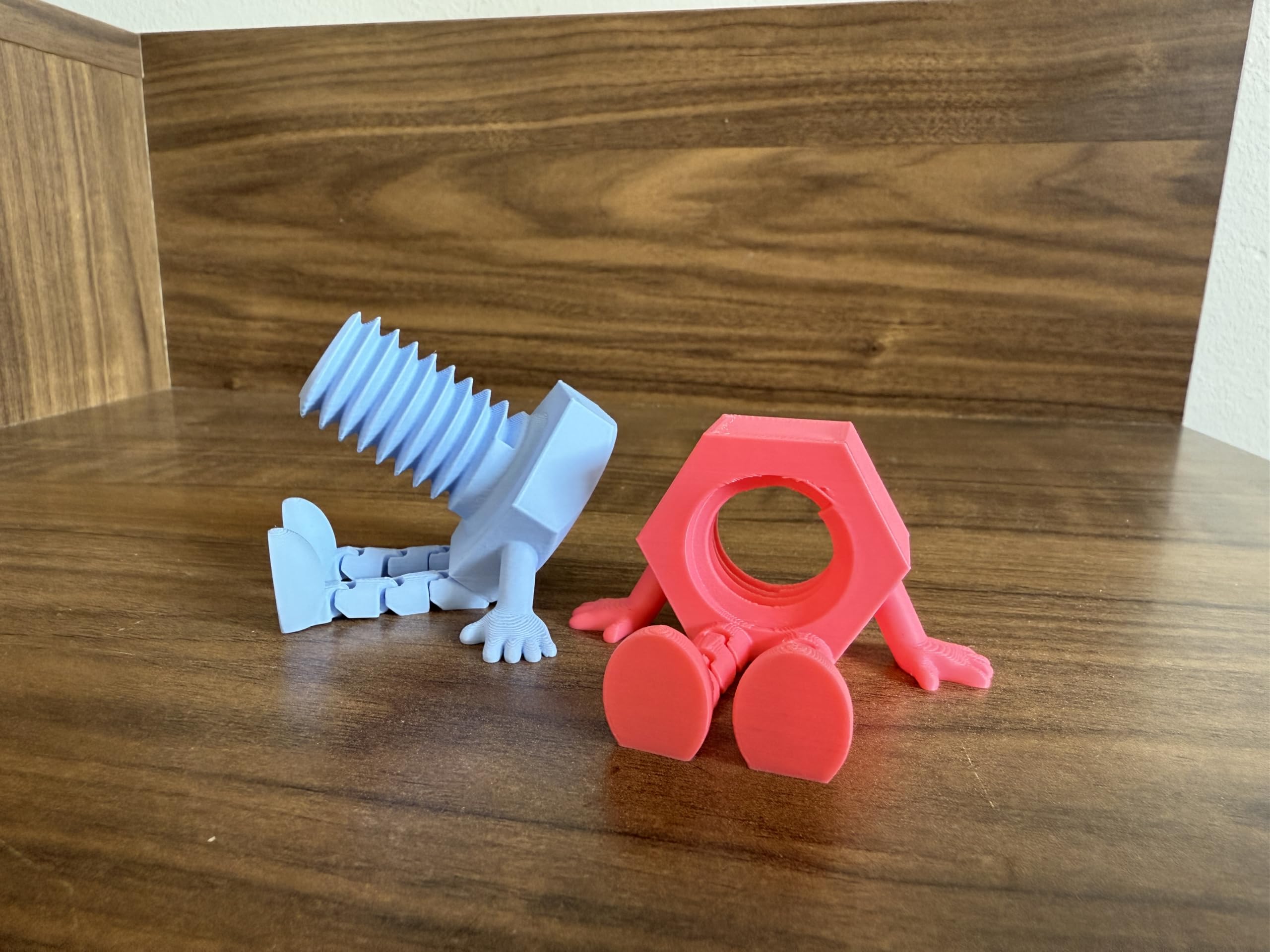Articulated bolt and nut figurine with legs
