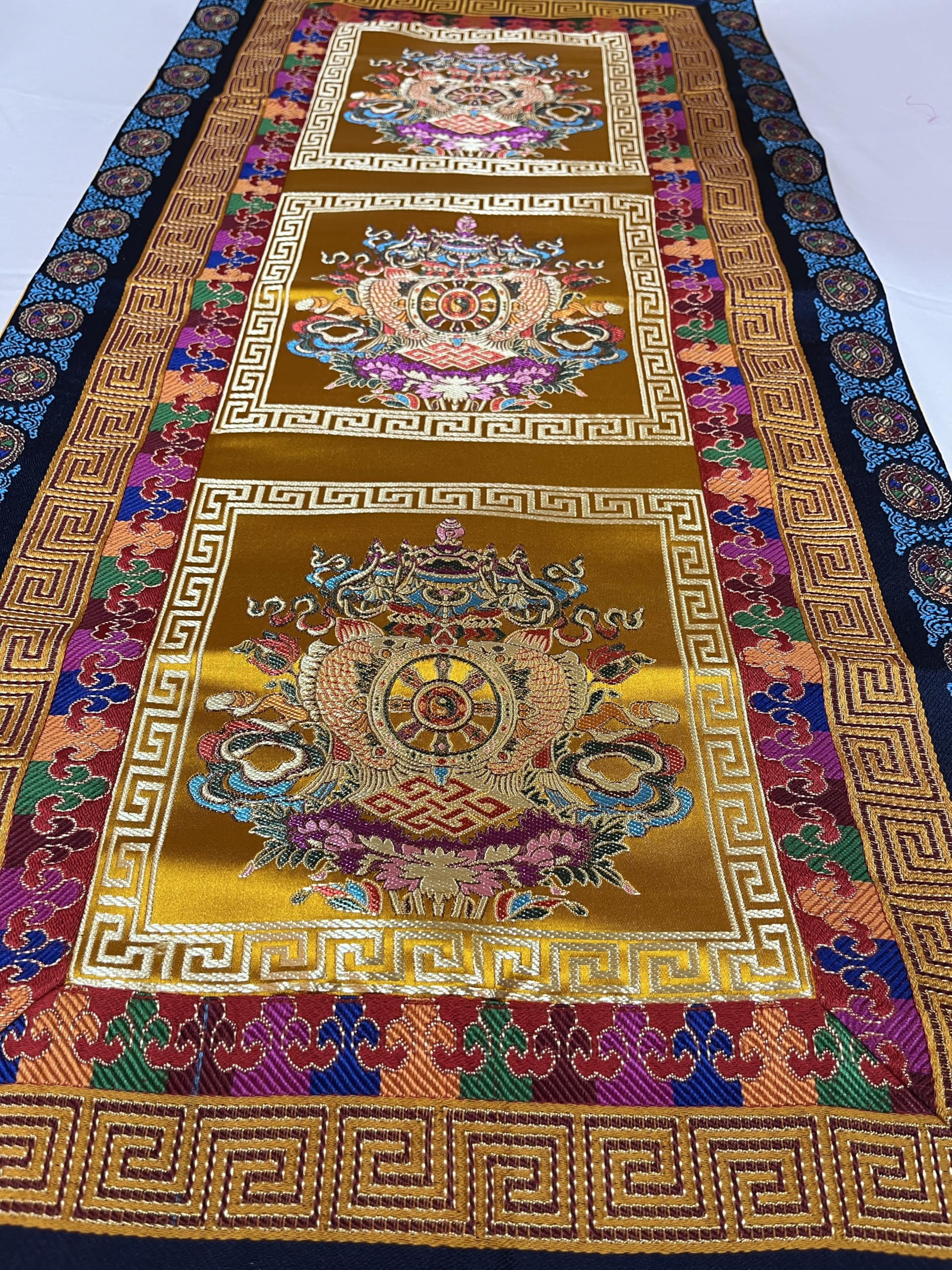 Yellow Nepal handmade table runner with wheel of life border and oriental design
