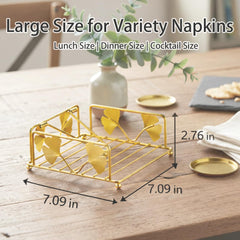 Gold finish napkin holder by Avolander featuring ginkgo leaf design