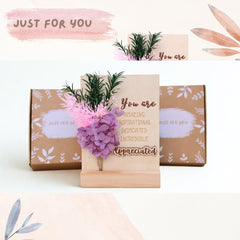 Desk decor with preserved purple hydrangea flowers in wooden base