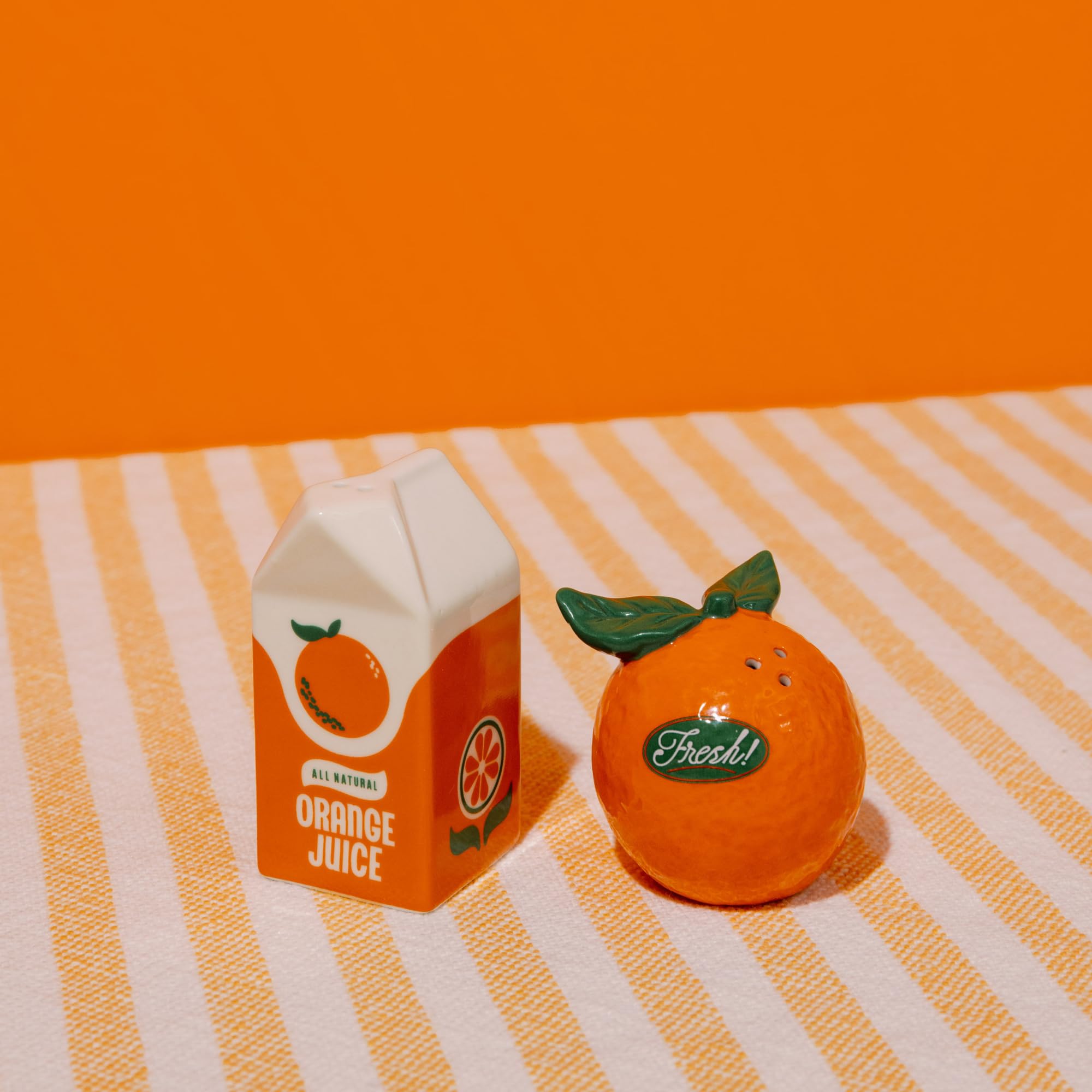 orange juice carton shaker and round orange shaker pair