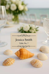 Beach wedding place cards displayed on starfish and seashell holders