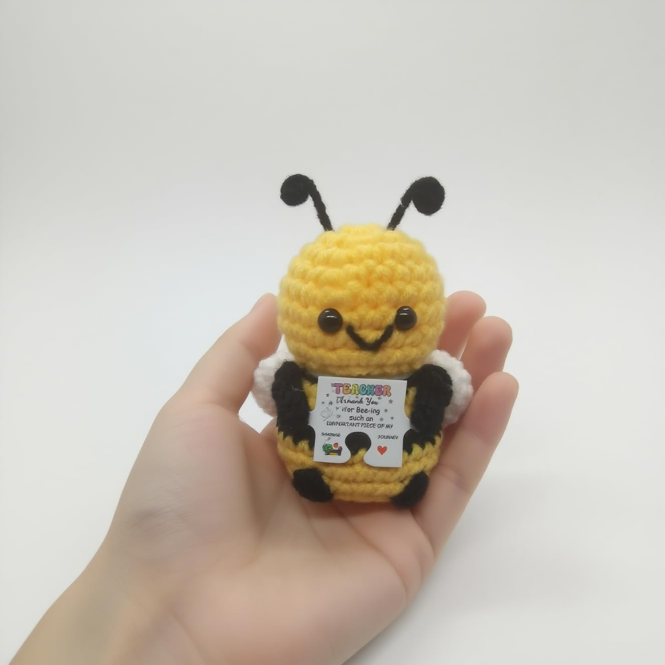 Compact bee plush about 2-3 inches tall with wooden stand