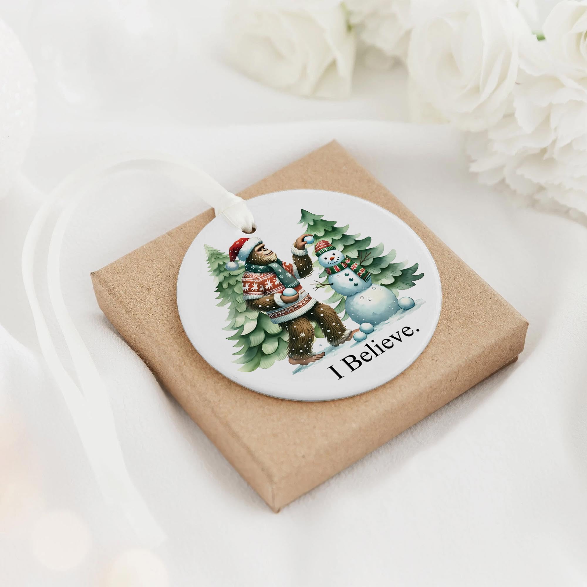 Snow-dusted pine trees scene on white ceramic ornament