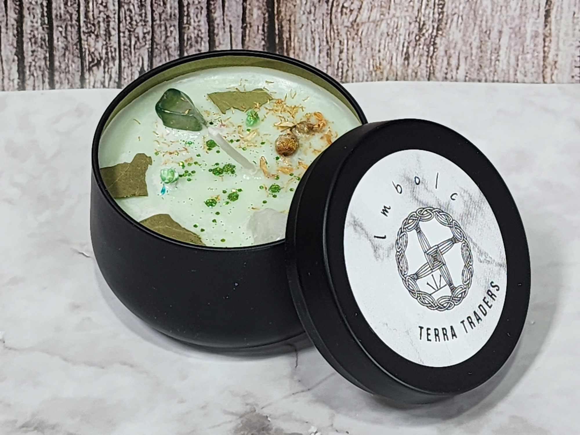 Rounded black matte metal container with lid for Imbolc candle
