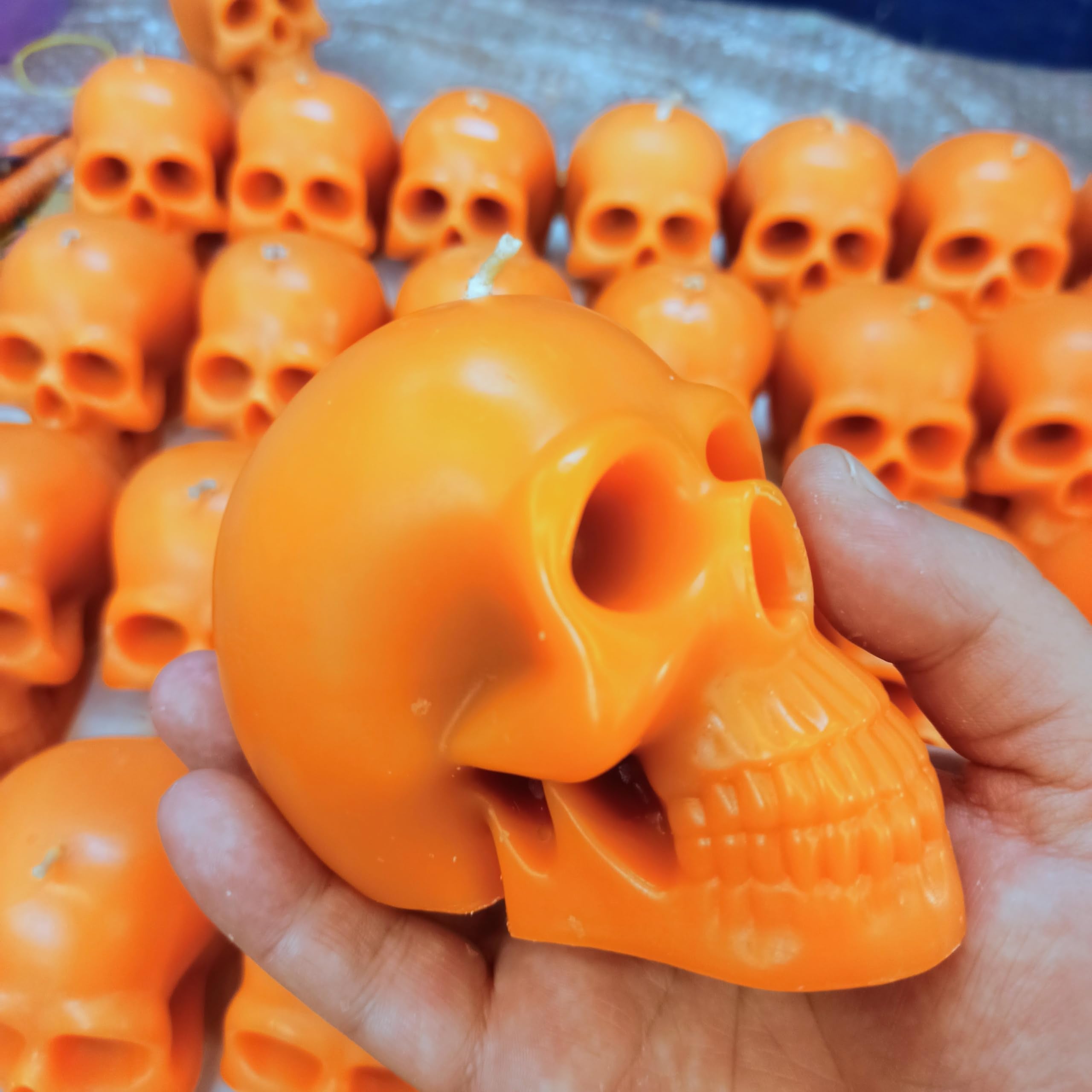 Orange red color skull candle suitable for rituals