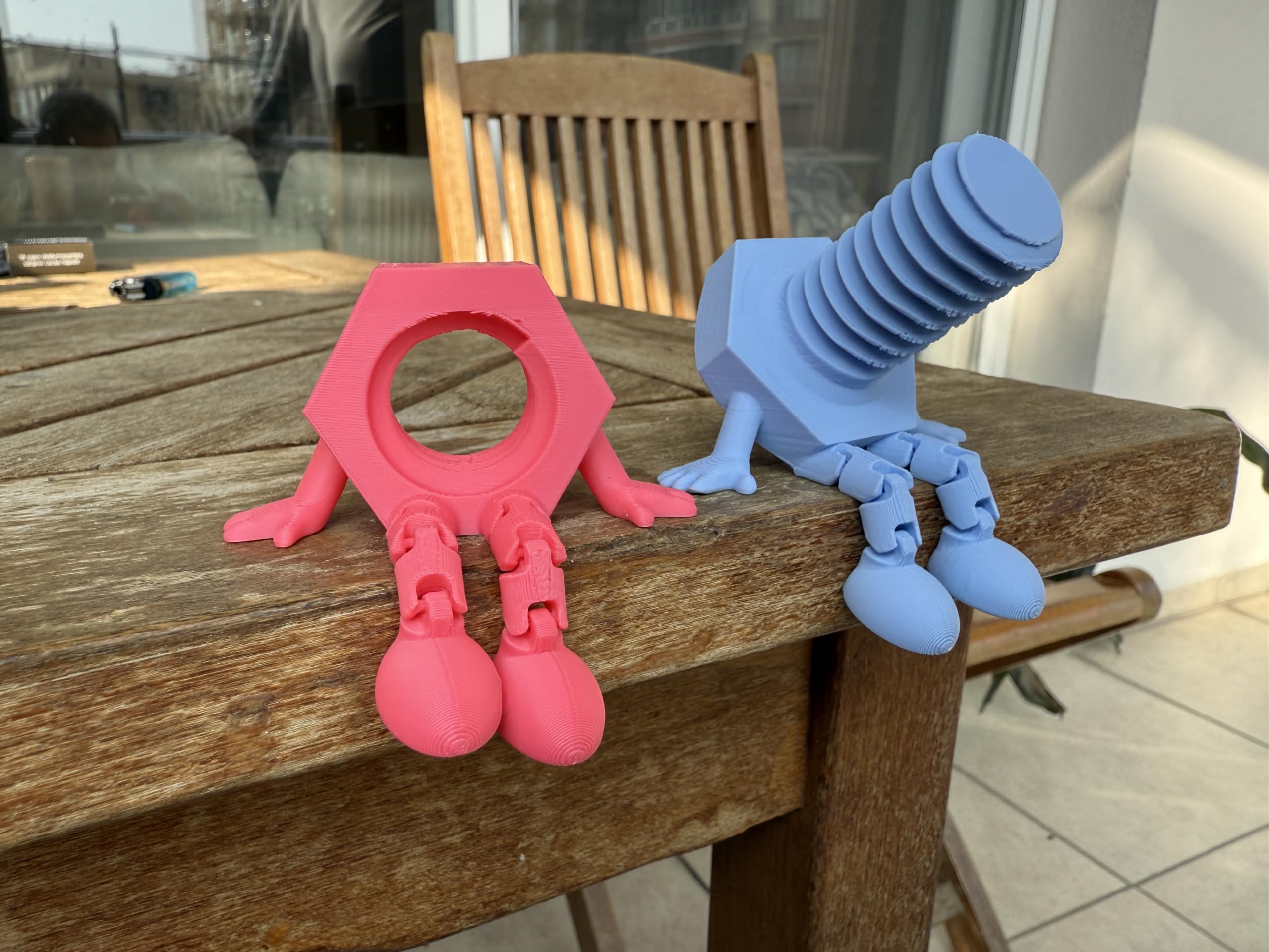 Bolt and nut figurine with articulated legs close up