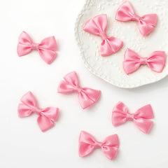 Ribbon bow magnets for refrigerator cabinets and whiteboards