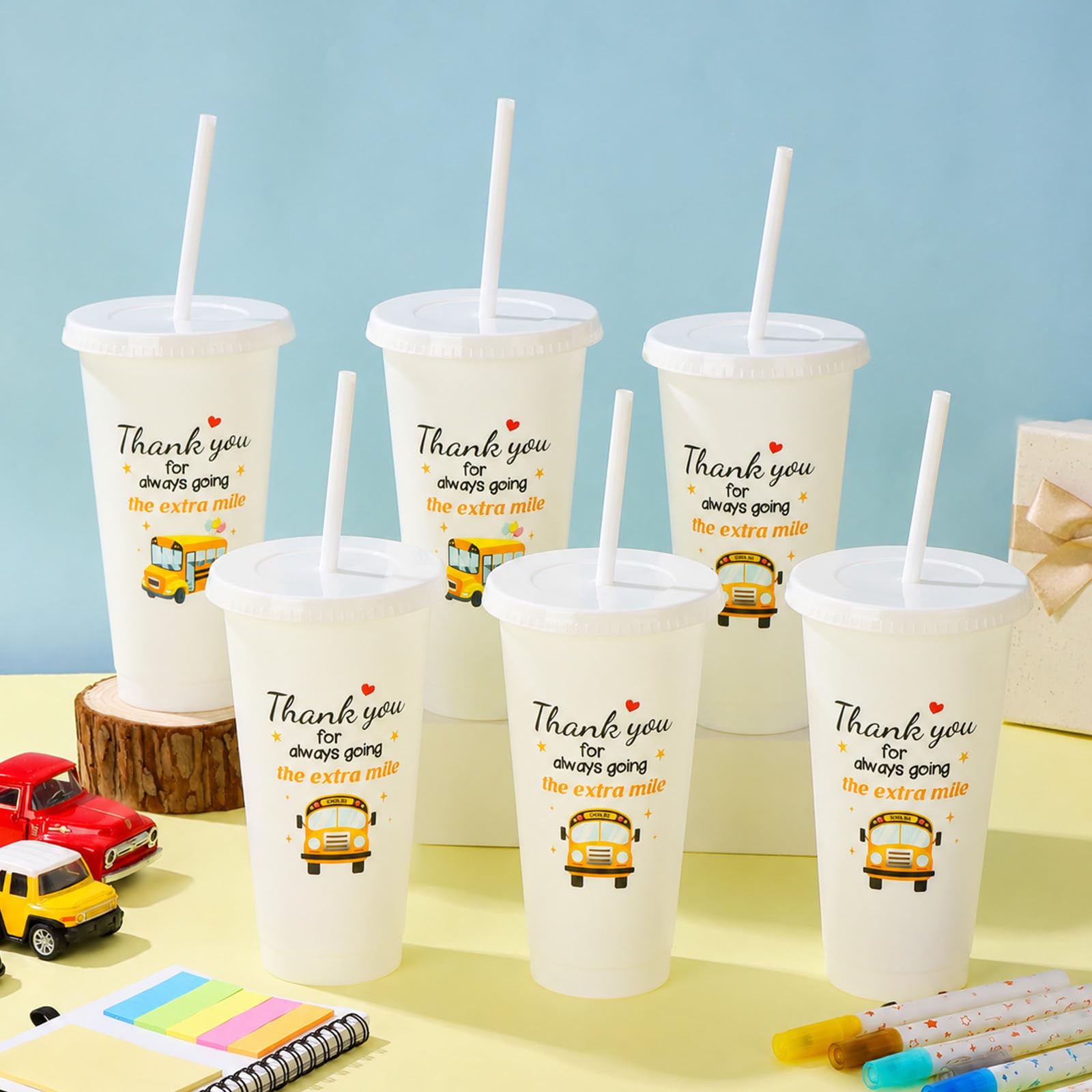 Cup featuring cartoon school bus pattern and star decorations on white cup
