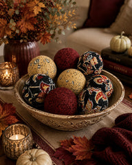 Two burgundy balls and two beige pumpkin-pattern balls in the set